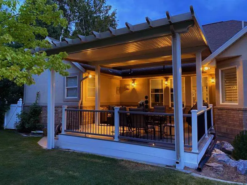 Warm-lit backyard patio cover in South Jordan, Utah