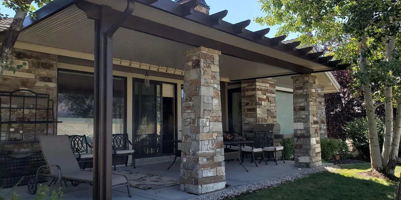 Solid aluminum awning providing weather cover beside a home
