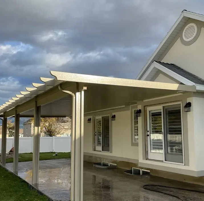 Utah Awnings patio cover keeping a backyard patio dry during rain