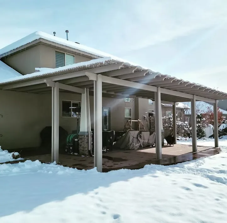 Covered patio structure by Utah Awnings surrounded by winter snow